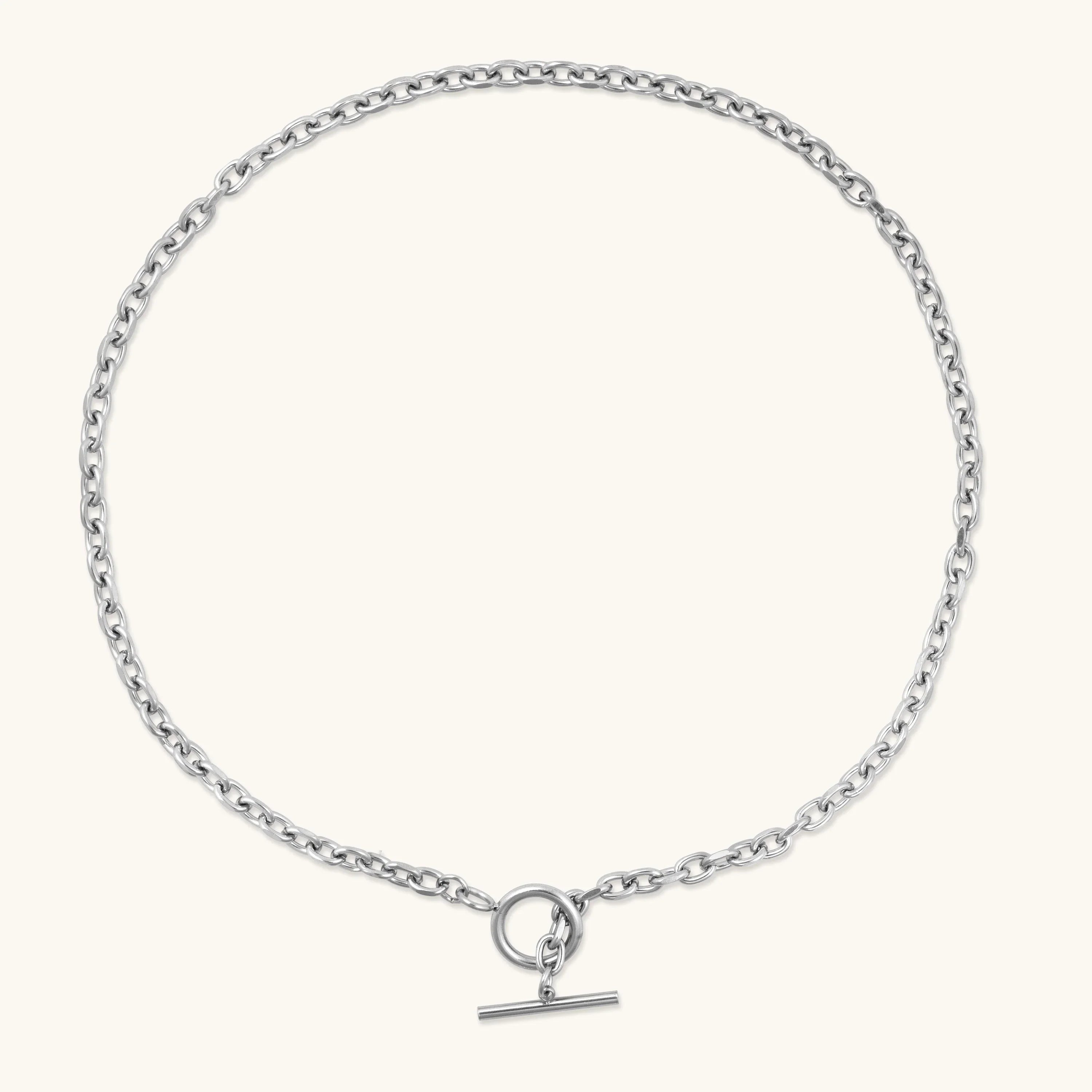Silver chain necklace with toggle clasp on a light background