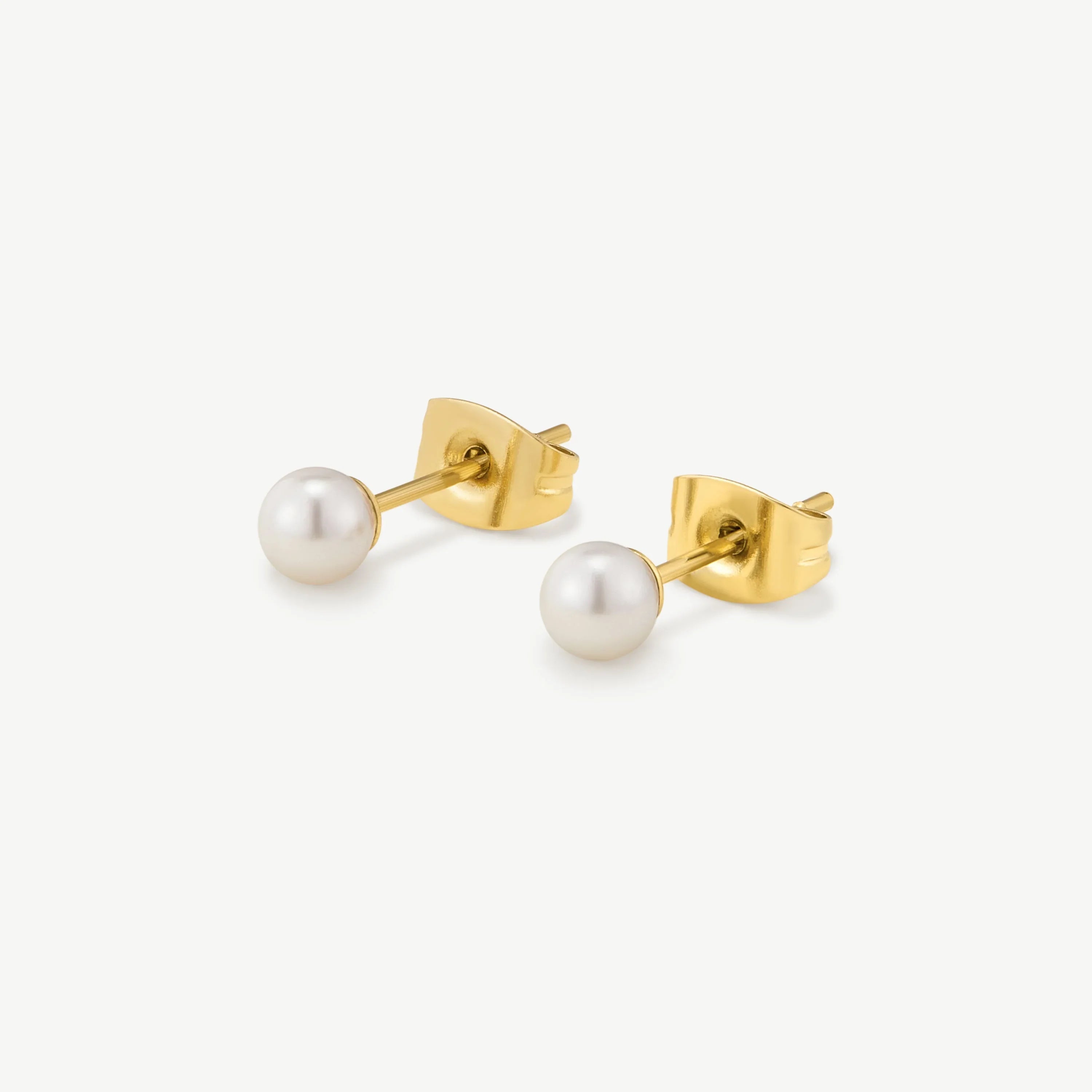 Pair of gold stud earrings with round white pearls on a white background