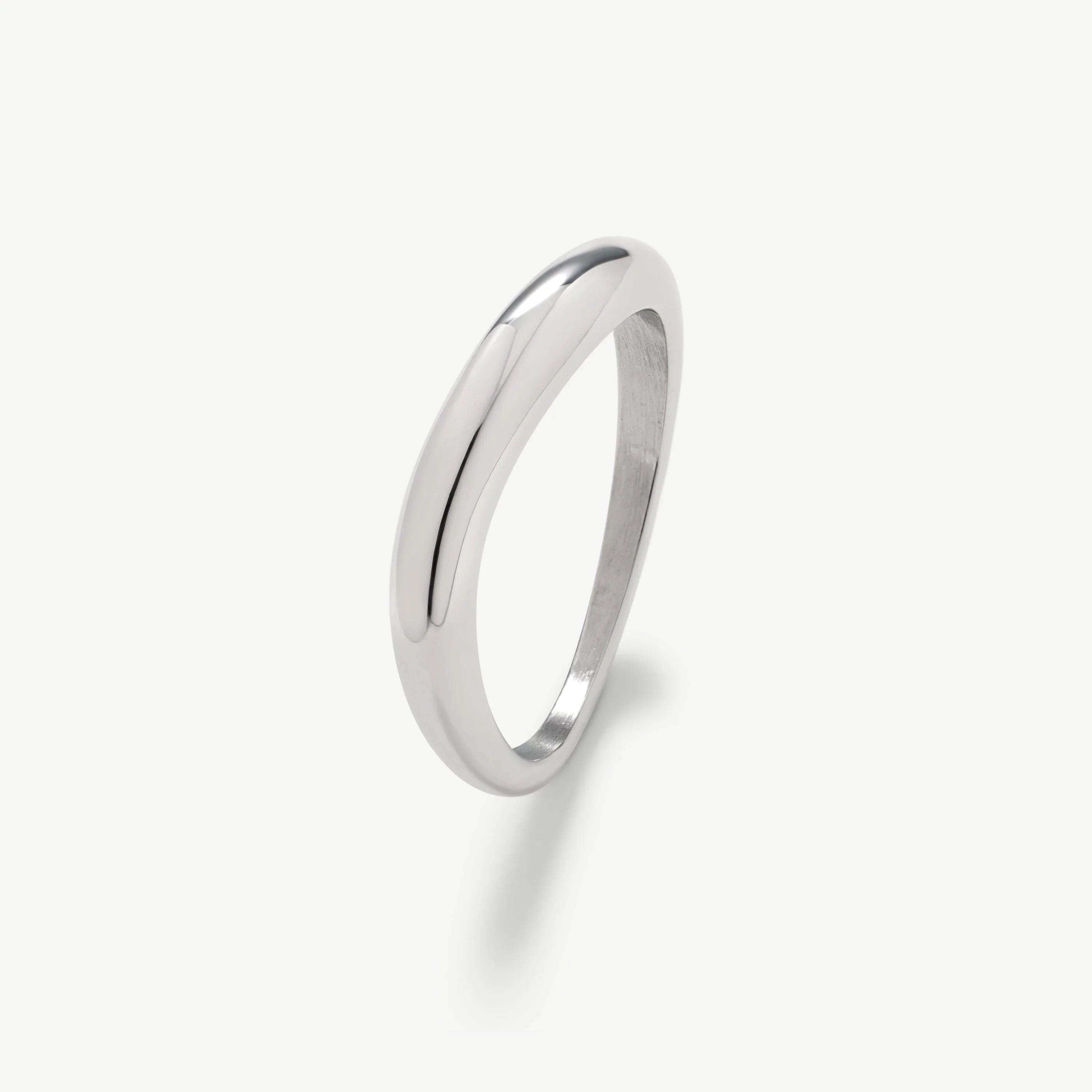 Simple polished silver band ring on white background with smooth rounded design