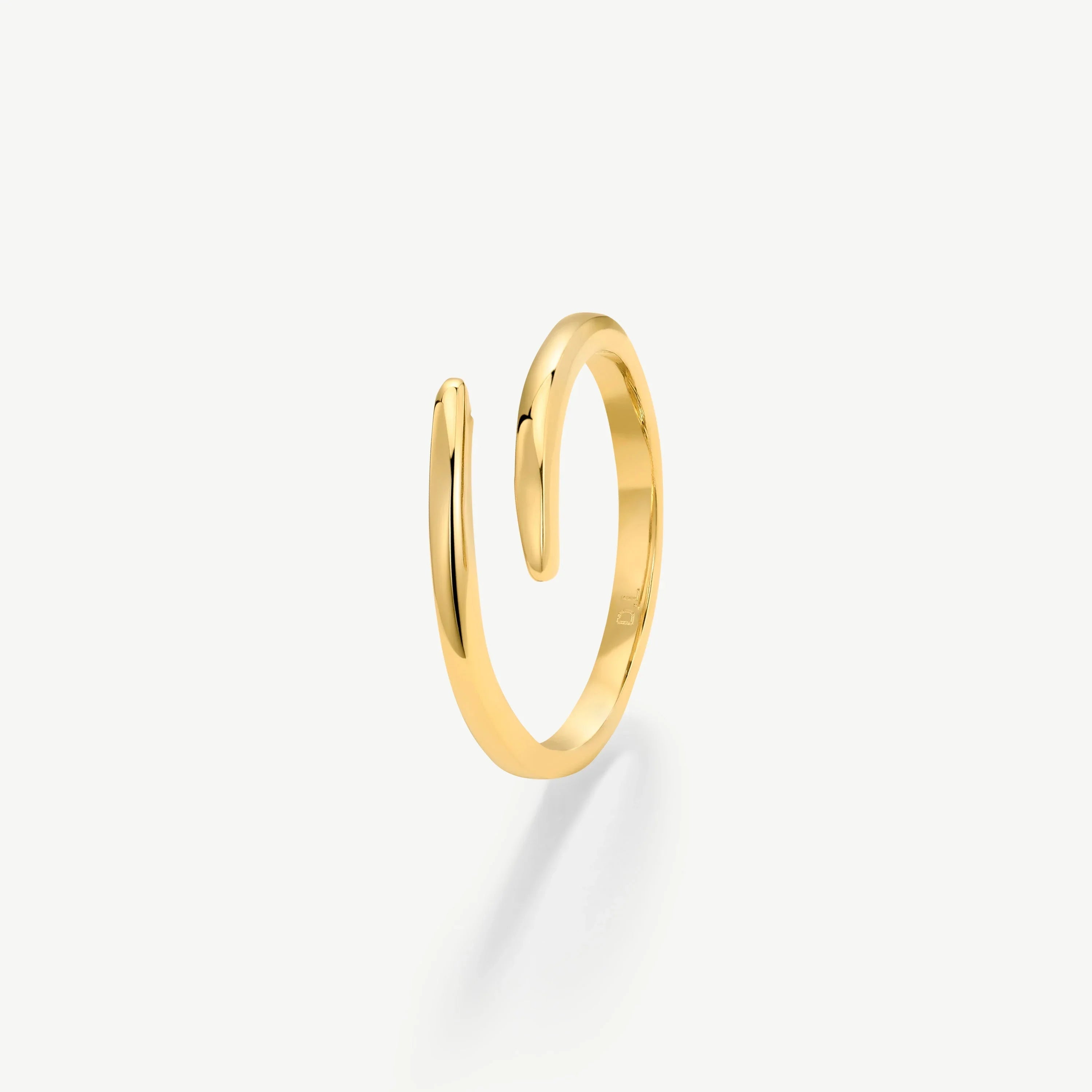 Minimalist open gold ring with polished finish on white background