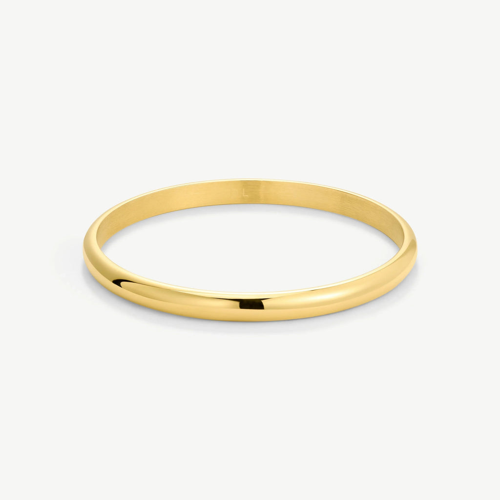 Simple polished gold bangle bracelet on white background
