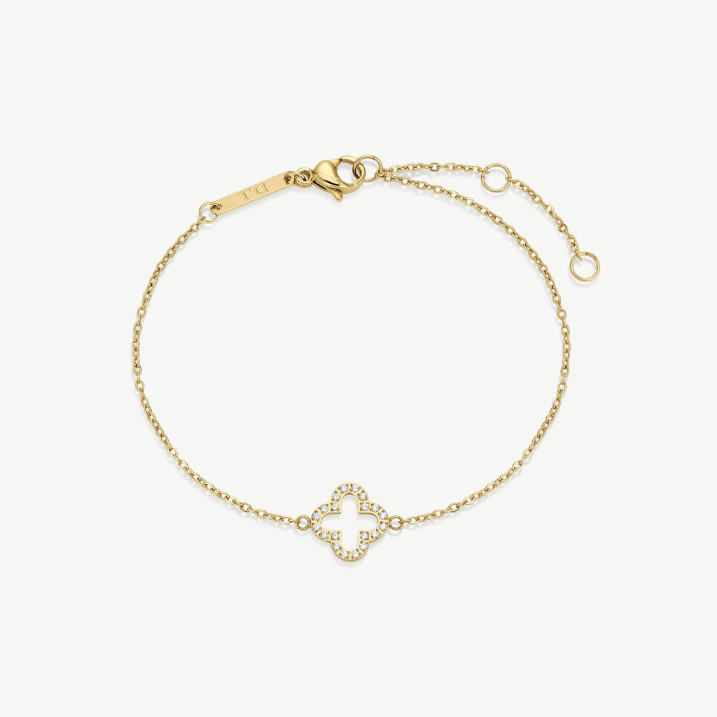 Delicate gold bracelet with clover-shaped diamond charm and adjustable chain clasp