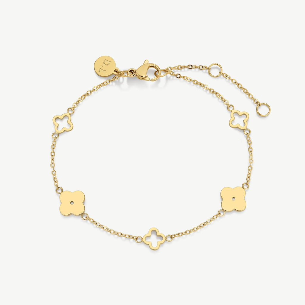 Delicate gold bracelet with clover-shaped charms and lobster clasp on white background