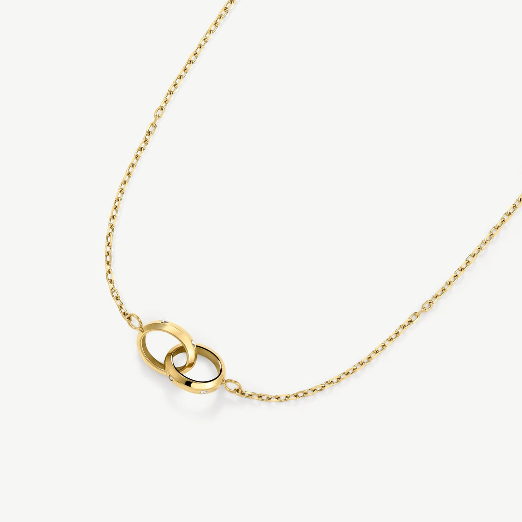 Gold necklace with two interlocking rings featuring small diamond accents on white background