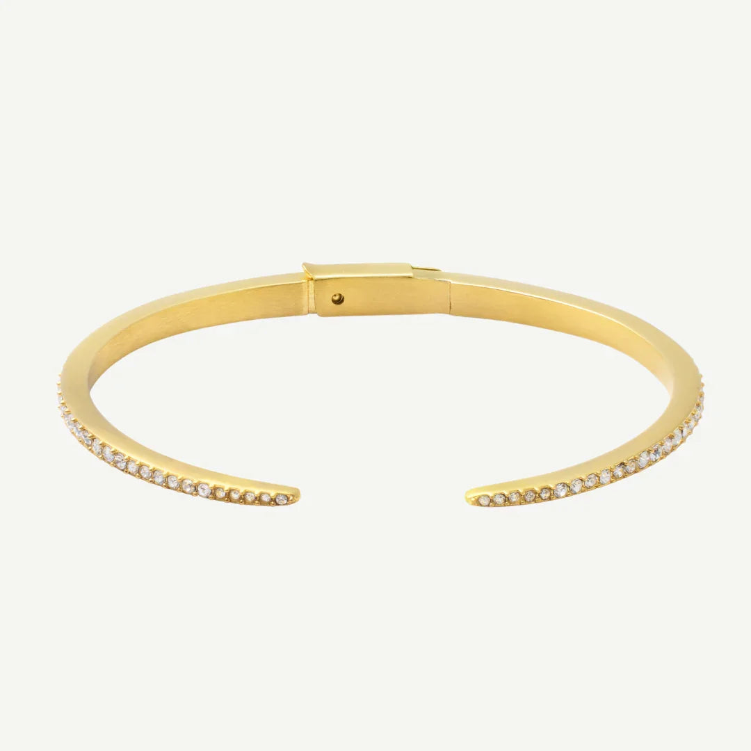 Elegant gold cuff bracelet with a row of small sparkling stones on each open end