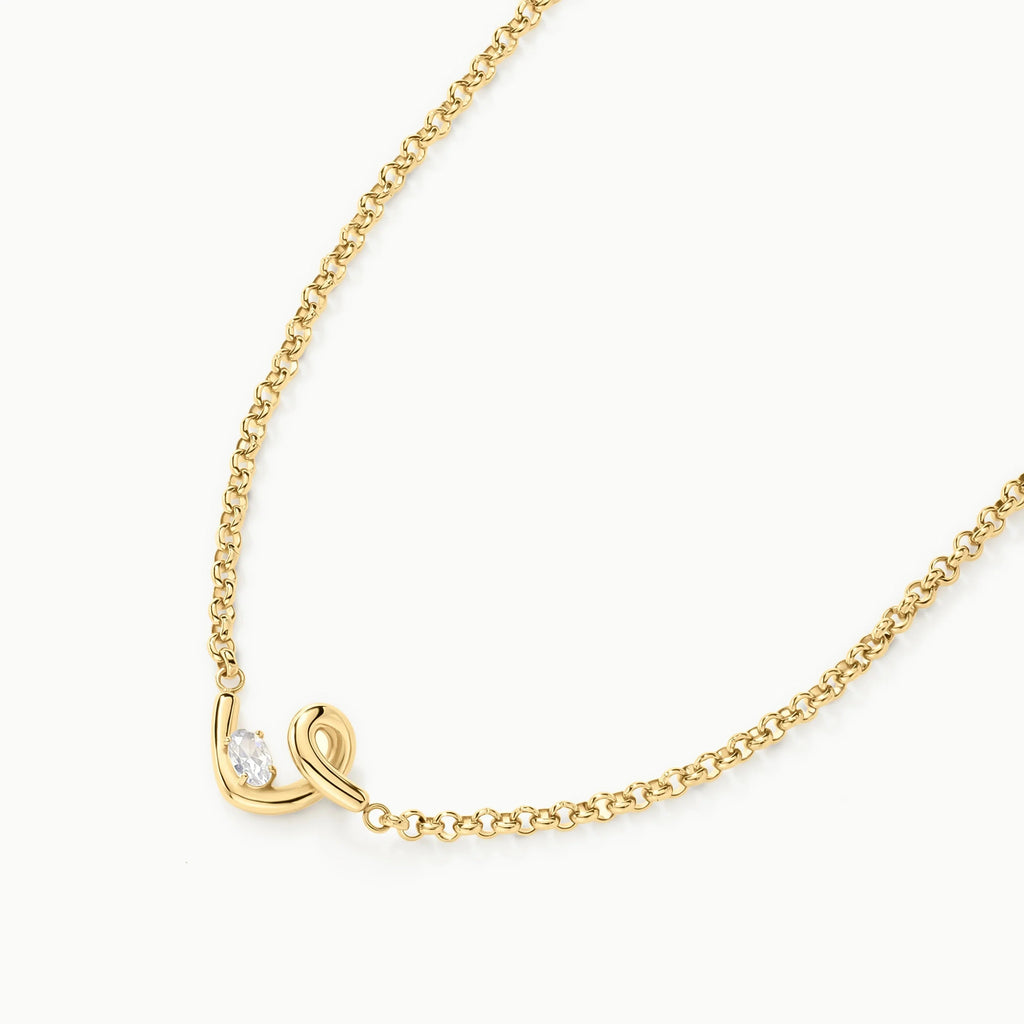 Elegant 14k gold necklace with a delicate curved pendant and oval clear gemstone