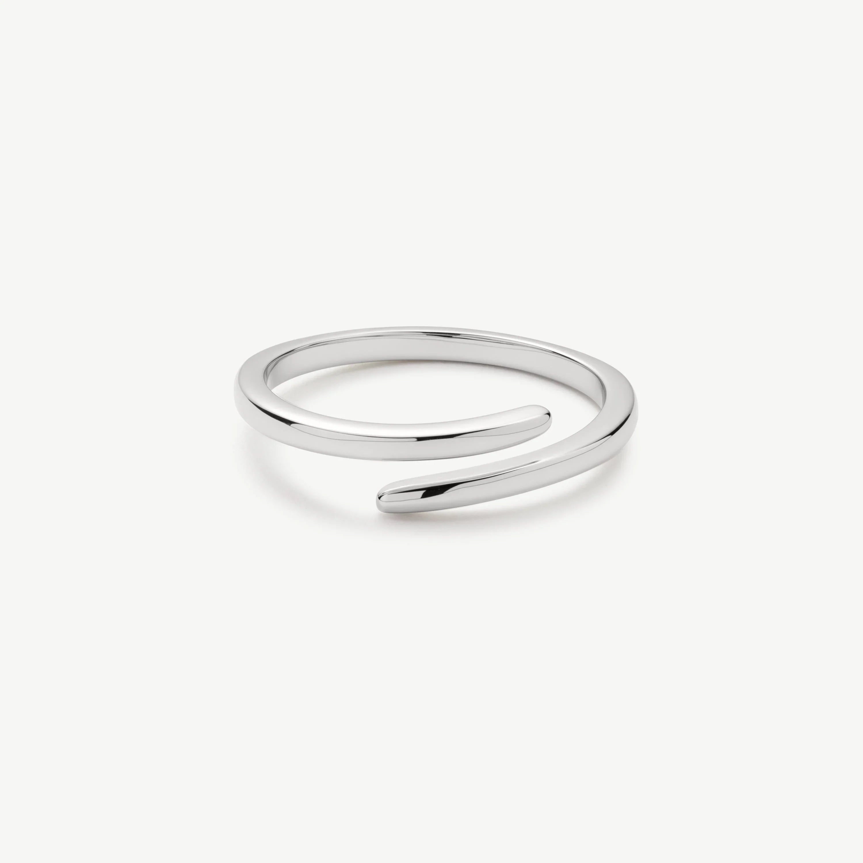 Minimalist silver open cuff bracelet with smooth polished finish on white background